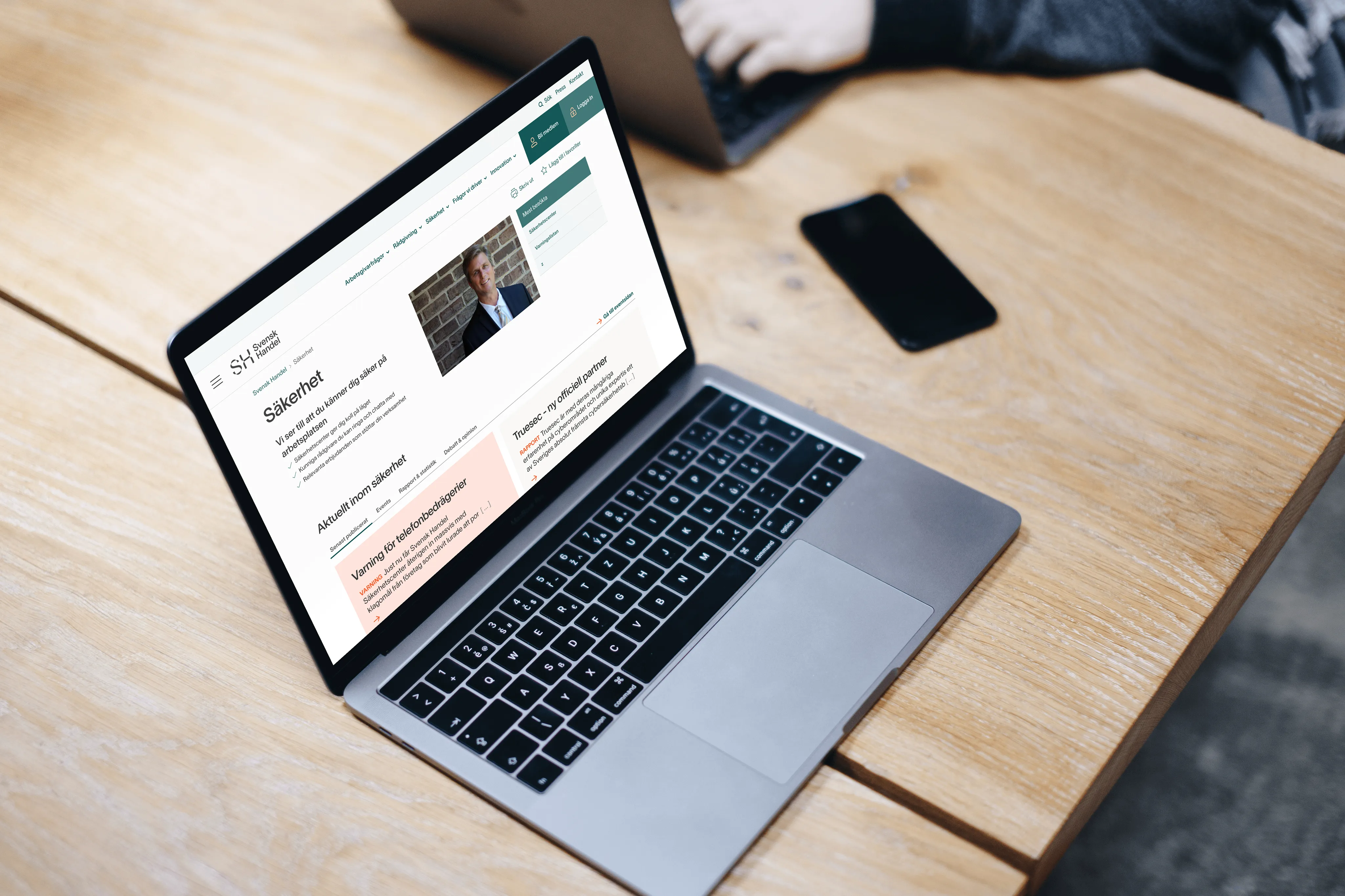 The redesigned Svensk Handel website open on a laptop on a wooden table